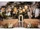 Charming outdoor event space featuring hanging lanterns, elegant seating, and an inviting floral archway at 1541 Bay Point Dr, Sarasota, FL 34236