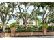 Beautiful two-story home with blue shutters, white columns, mature trees, and landscaped front yard at 1541 Bay Point Dr, Sarasota, FL 34236