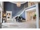 Grand foyer with a curved staircase, piano, chandelier, and beautiful white-painted wood floors at 1541 Bay Point Dr, Sarasota, FL 34236
