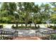 Circular driveway featuring brick accents, wrought iron railings, lush landscaping, and a grand entrance at 1541 Bay Point Dr, Sarasota, FL 34236