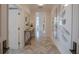 Bright hallway with tile flooring, decorative table, and modern artwork at 1541 Bay Point Dr, Sarasota, FL 34236