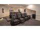 Home theater with rows of reclining seats and an illuminated screen at 1541 Bay Point Dr, Sarasota, FL 34236