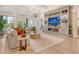 Bright living room with a modern entertainment center, fireplace, and comfortable seating at 1541 Bay Point Dr, Sarasota, FL 34236