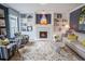 Cozy living room with a marble fireplace, built-in shelving, plush seating, and a patterned rug at 1541 Bay Point Dr, Sarasota, FL 34236