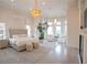 Bright primary bedroom with a sitting area, chandelier lighting, and luxury finishes at 1541 Bay Point Dr, Sarasota, FL 34236