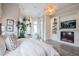 Spacious primary bedroom with fireplace, built-ins, sitting area, and bright natural light at 1541 Bay Point Dr, Sarasota, FL 34236