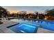 Relaxing spa and long pool are illuminated at sunset with professional lighting and mature landscaping at 1541 Bay Point Dr, Sarasota, FL 34236