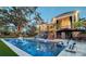 Luxurious pool area featuring a spa, outdoor kitchen, and covered patio for relaxation and entertainment at 1541 Bay Point Dr, Sarasota, FL 34236