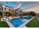 Luxury home featuring a long pool, patio area, outdoor seating, and manicured lawn at 1541 Bay Point Dr, Sarasota, FL 34236