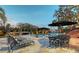 Backyard patio with pool, fire feature, lounge chairs, dining set, and lush greenery perfect for outdoor entertaining at 1541 Bay Point Dr, Sarasota, FL 34236