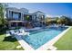 Luxury outdoor pool with an outdoor kitchen, elegant patio furniture, and stunning architectural details at 1541 Bay Point Dr, Sarasota, FL 34236