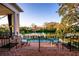 Outdoor pool overlooking the waterway, framed by landscaped garden and steps from patio at 1541 Bay Point Dr, Sarasota, FL 34236