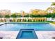 Elevated view of pool and hot tub overlooking canal at 1541 Bay Point Dr, Sarasota, FL 34236