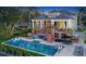 Luxury home with expansive pool, outdoor seating, lush landscaping, and unique brick staircase at 1541 Bay Point Dr, Sarasota, FL 34236