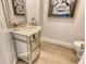 Stylish powder room featuring a mirrored vanity, marble countertop, and decorative details at 1541 Bay Point Dr, Sarasota, FL 34236