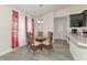 Cozy breakfast nook with round glass table and rattan chairs, adjacent to the kitchen at 2155 Jagust Rd, North Port, FL 34288