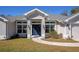 Charming single-story home featuring a neatly maintained lawn and a welcoming blue front door at 2155 Jagust Rd, North Port, FL 34288
