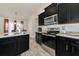 Modern kitchen features stainless steel appliances and dark cabinets at 2155 Jagust Rd, North Port, FL 34288