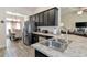 Kitchen featuring stainless steel appliances, dark cabinets, and gray tile flooring at 2155 Jagust Rd, North Port, FL 34288