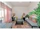 Cozy sitting area with patterned sofa, plants, and natural light at 2155 Jagust Rd, North Port, FL 34288