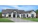 Single-story home with gray roof, white siding, and a three-car garage at 2417 Waterfront Cir, Sarasota, FL 34240