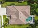 Overhead shot showcasing a tile roof, screened pool area, and meticulously maintained landscaping at 2737 Harvest Dr, Sarasota, FL 34240