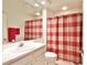 Bathroom featuring a single sink vanity and a shower with a red and white checkered curtain at 2737 Harvest Dr, Sarasota, FL 34240