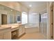 Bright and spacious bathroom with dual sinks, a soaking tub, and a separate glass-enclosed shower at 2737 Harvest Dr, Sarasota, FL 34240