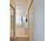 Hallway view of luxurious bathroom with a separate shower, soaking tub, and ample closet space at 2737 Harvest Dr, Sarasota, FL 34240