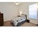 Bedroom with a single bed, window, neutral carpet, and a bedside table with a lamp at 2737 Harvest Dr, Sarasota, FL 34240