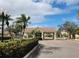 Beautiful community entrance with lush landscaping and palm trees at 2737 Harvest Dr, Sarasota, FL 34240