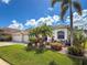Lovely one-story home showcasing a three-car garage, lush landscaping, and charming curb appeal at 2737 Harvest Dr, Sarasota, FL 34240