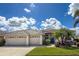 Attractive single-story home boasting a three-car garage, paver driveway, and manicured lawn at 2737 Harvest Dr, Sarasota, FL 34240
