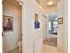 Hallway showcasing a decorative mirror and leading to a bedroom, with a bathroom visible to the left at 2737 Harvest Dr, Sarasota, FL 34240