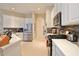 Bright kitchen featuring stainless steel appliances, white cabinets, tile flooring, and stone backsplash at 2737 Harvest Dr, Sarasota, FL 34240