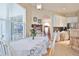 Bright kitchen nook with a round table, white cabinets, tile floor, and stainless steel appliances at 2737 Harvest Dr, Sarasota, FL 34240