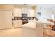 Bright kitchen featuring white cabinets, stainless steel appliances, stone backsplash, and a breakfast bar at 2737 Harvest Dr, Sarasota, FL 34240