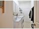 Functional laundry room with washer, dryer, storage cabinets, and a utility sink at 2737 Harvest Dr, Sarasota, FL 34240