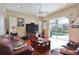 Inviting living room with pool view, features hardwood floors and access to the outdoor living space at 2737 Harvest Dr, Sarasota, FL 34240