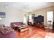 Spacious living room with hardwood floors, ceiling fan, comfortable sofas, and a large television at 2737 Harvest Dr, Sarasota, FL 34240