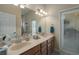 Double sink bathroom vanity with large mirror, cabinet storage and neutral tones at 3439 101St E Ave, Parrish, FL 34219