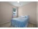 Neutral bedroom featuring a ceiling fan and a window with a white curtain at 3439 101St E Ave, Parrish, FL 34219