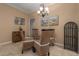 Charming dining area featuring a glass-top table, wicker chairs, and beach-themed decor at 3439 101St E Ave, Parrish, FL 34219