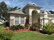 Charming home exterior with manicured landscaping, stone accents, and an inviting arched entryway at 3439 101St E Ave, Parrish, FL 34219