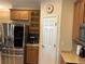 Kitchen boasts stainless steel refrigerator and seamlessly integrates storage solutions for a modern aesthetic at 3439 101St E Ave, Parrish, FL 34219