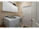 Well-equipped laundry room with white cabinets and modern washer-dryer set for convenience at 3439 101St E Ave, Parrish, FL 34219