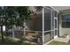 Screened patio with dining table and wicker chairs, perfect for outdoor entertaining at 3439 101St E Ave, Parrish, FL 34219
