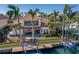Expansive waterfront backyard with a private pool, lush landscaping, and a dock for boating, great for outdoor living at 367 W Royal Flamingo Dr, Sarasota, FL 34236