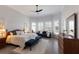 Bright bedroom with large windows, plantation shutters, and a sitting area with a loveseat at 367 W Royal Flamingo Dr, Sarasota, FL 34236