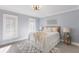 Cozy bedroom featuring a comfortable bed, stylish decor, and natural light from shuttered windows at 367 W Royal Flamingo Dr, Sarasota, FL 34236